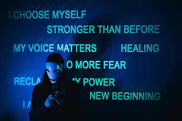 Abuse survivor wearing a white mask in front of motivational quotes about healing, self-worth, and overcoming domestic violence.